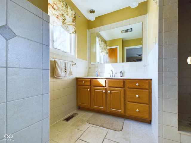 bathroom with vanity and tile walls