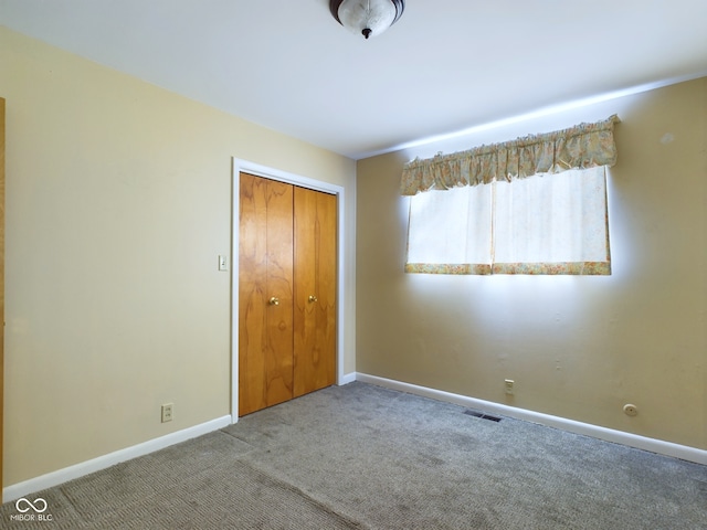 unfurnished bedroom featuring a closet and carpet flooring