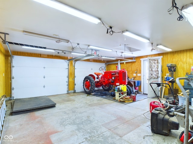 garage featuring wood walls