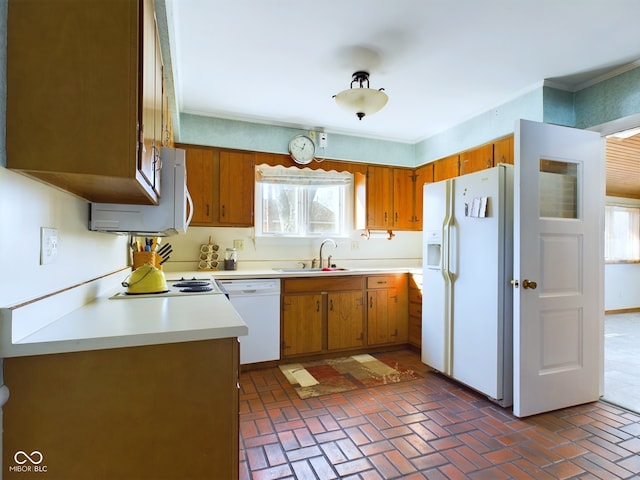 kitchen featuring plenty of natural light, sink, and white appliances