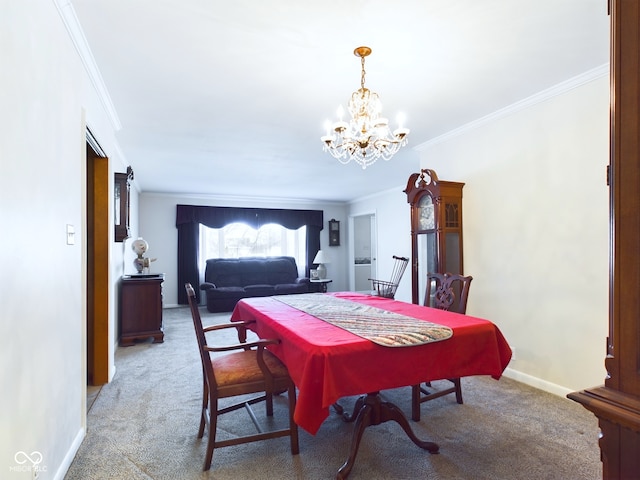 carpeted dining space featuring crown molding and a chandelier