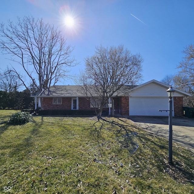 ranch-style home with brick siding, an attached garage, concrete driveway, and a front lawn