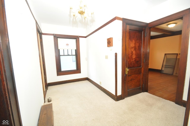 hall with a chandelier and carpet