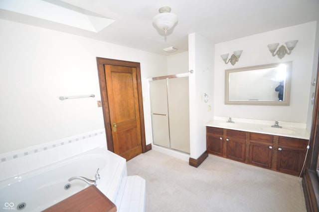 bathroom with plus walk in shower, vanity, and a skylight