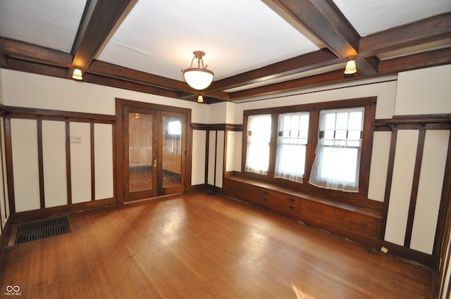 spare room with coffered ceiling, wood-type flooring, and beam ceiling