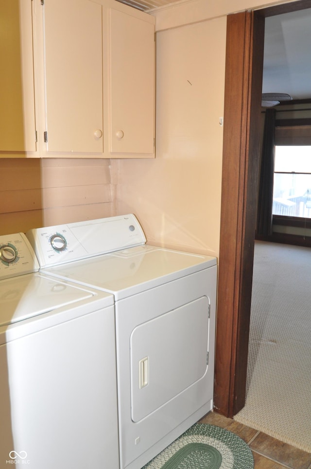 laundry area with cabinets and washing machine and clothes dryer