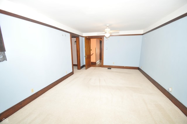 carpeted empty room featuring ceiling fan