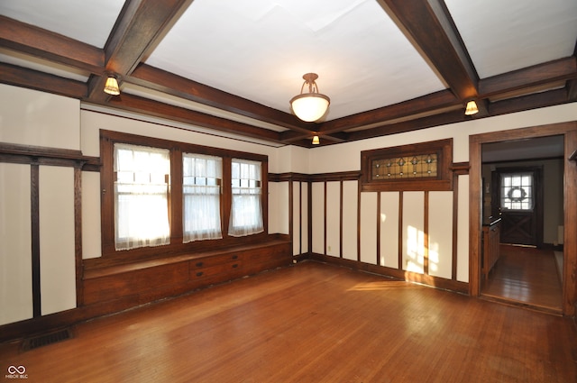 spare room featuring beamed ceiling, coffered ceiling, and dark wood-type flooring