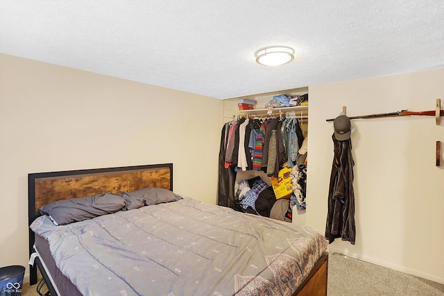 carpeted bedroom with a closet and a textured ceiling