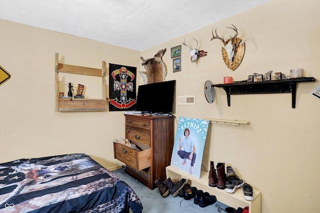 carpeted bedroom featuring a textured ceiling