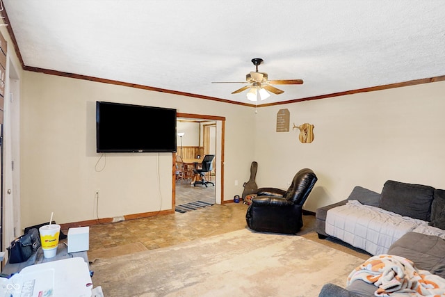 living room featuring ceiling fan, ornamental molding, and a textured ceiling