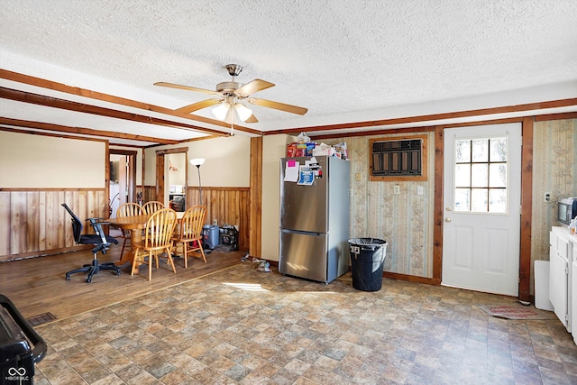 dining room featuring ceiling fan and a textured ceiling