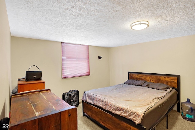 carpeted bedroom featuring a textured ceiling