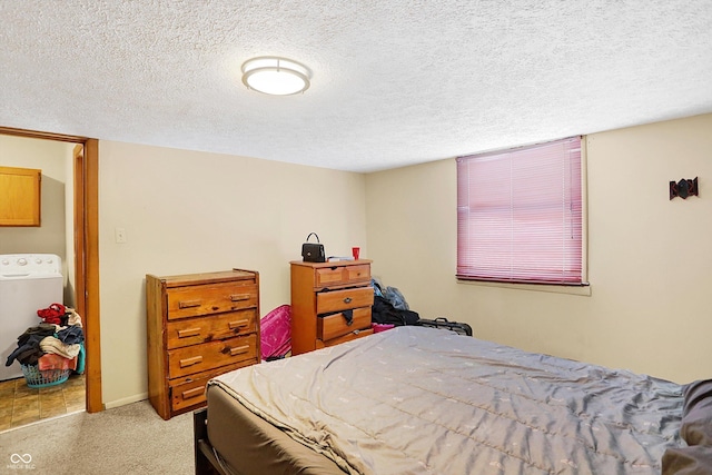 bedroom with washer / dryer and a textured ceiling