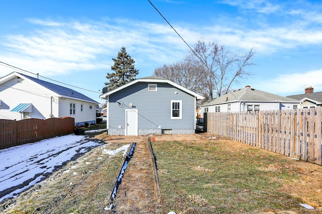 rear view of property with a lawn