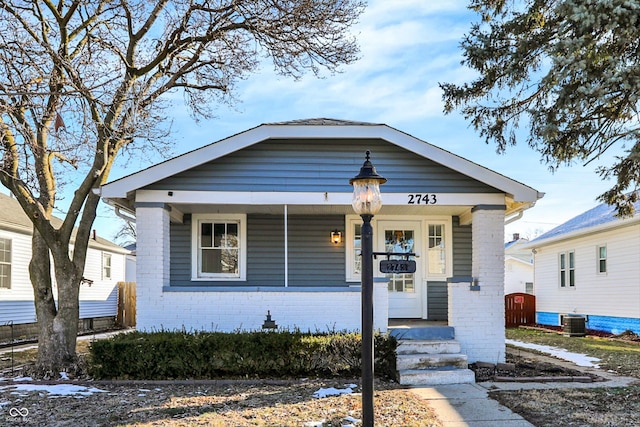 bungalow-style home featuring cooling unit and covered porch