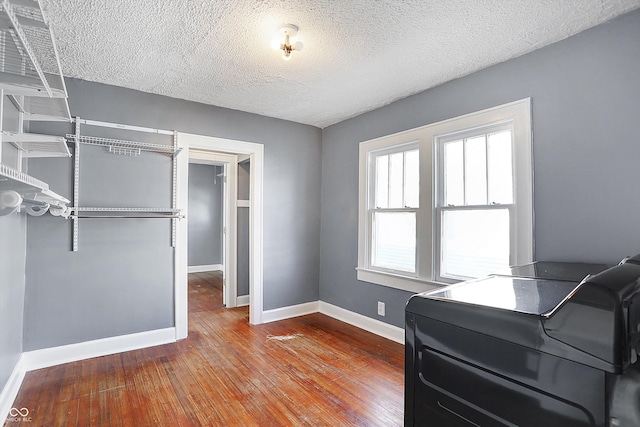 office space with hardwood / wood-style flooring, washer / dryer, and a textured ceiling