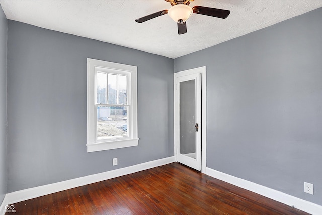 unfurnished room featuring ceiling fan, dark hardwood / wood-style floors, and a textured ceiling