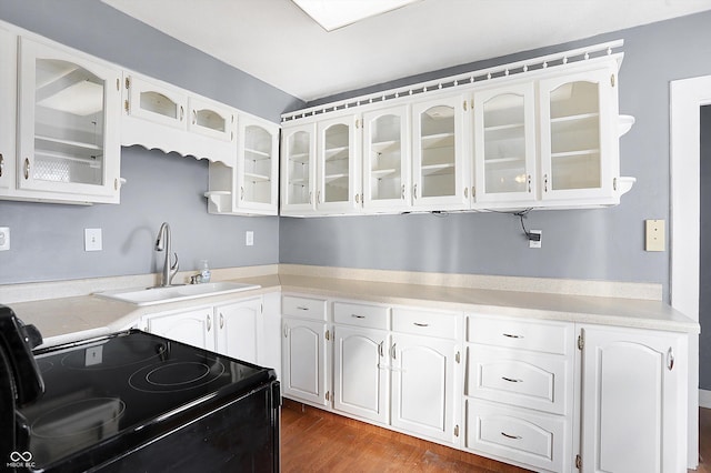 kitchen with white cabinetry, sink, dark wood-type flooring, and black electric range