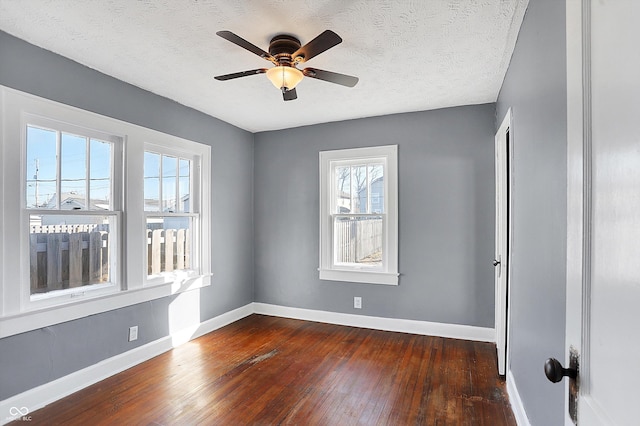 unfurnished room with dark wood-type flooring, ceiling fan, and a textured ceiling