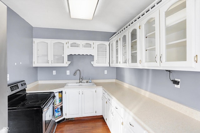 kitchen with white cabinetry, sink, dark hardwood / wood-style flooring, and stainless steel range with electric stovetop