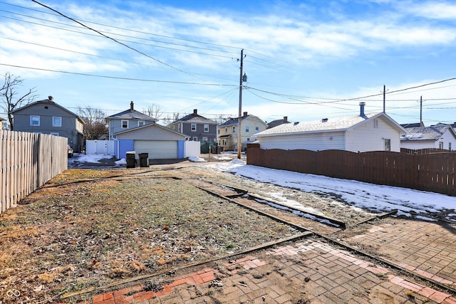 snowy yard with an outbuilding and a garage