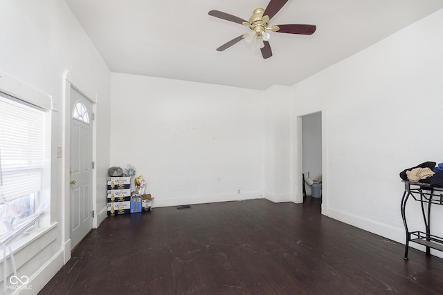 empty room featuring dark hardwood / wood-style flooring and ceiling fan