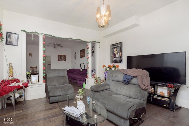 living room featuring an inviting chandelier and dark hardwood / wood-style flooring