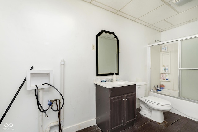 full bathroom featuring a paneled ceiling, shower / bath combination with glass door, vanity, wood-type flooring, and toilet