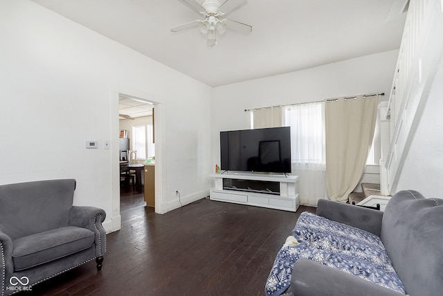 living room with dark wood-type flooring and ceiling fan