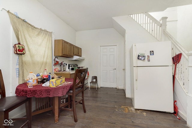 interior space with dark hardwood / wood-style flooring and white fridge