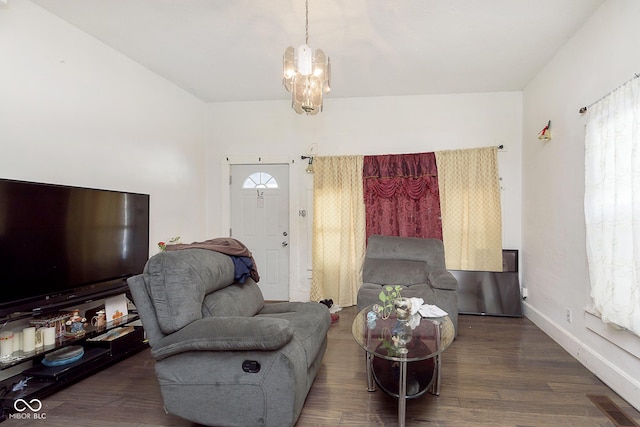 living room with an inviting chandelier and dark hardwood / wood-style flooring