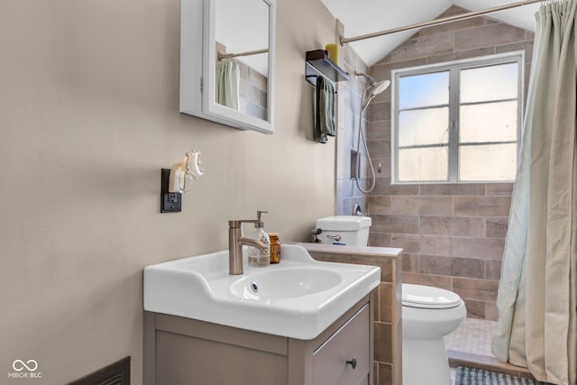 bathroom featuring vanity, a shower with curtain, lofted ceiling, and toilet