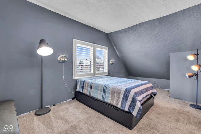 carpeted bedroom featuring lofted ceiling and a textured ceiling