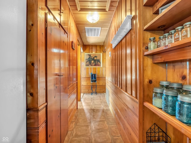 corridor with wooden ceiling and wood walls