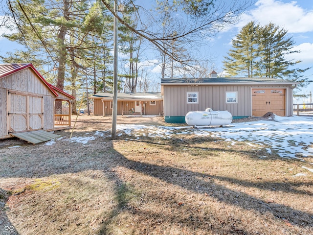 view of yard featuring a garage and a storage unit