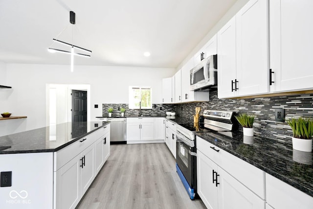 kitchen with pendant lighting, white cabinetry, and stainless steel appliances