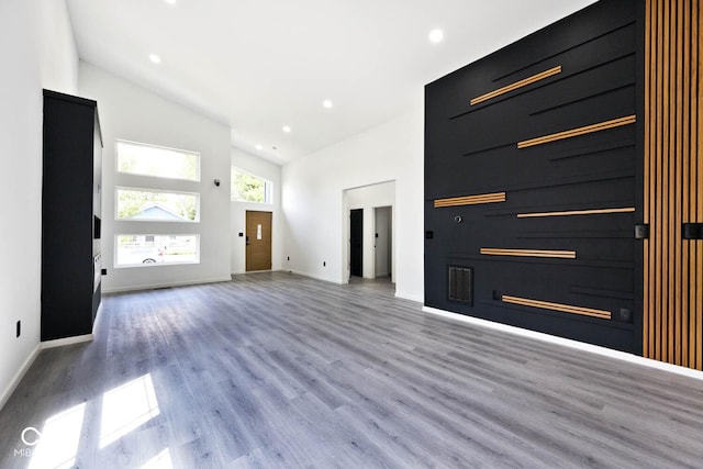 entryway with a towering ceiling and light hardwood / wood-style floors