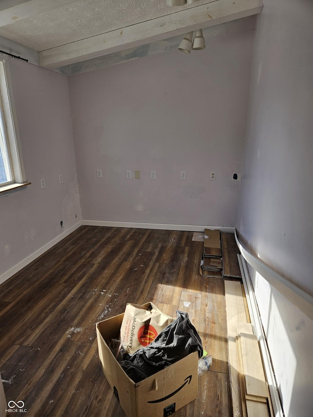 spare room featuring dark wood-type flooring