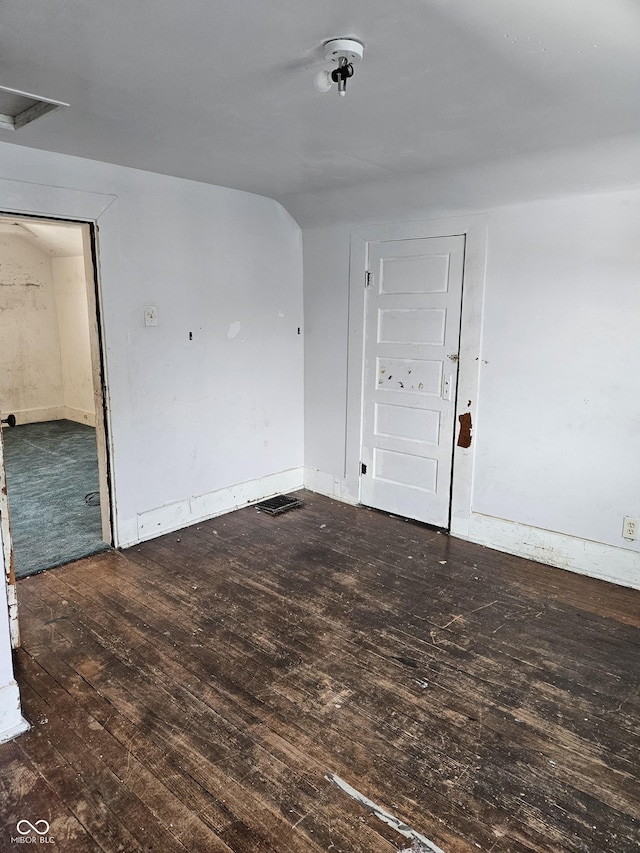 spare room with dark hardwood / wood-style floors