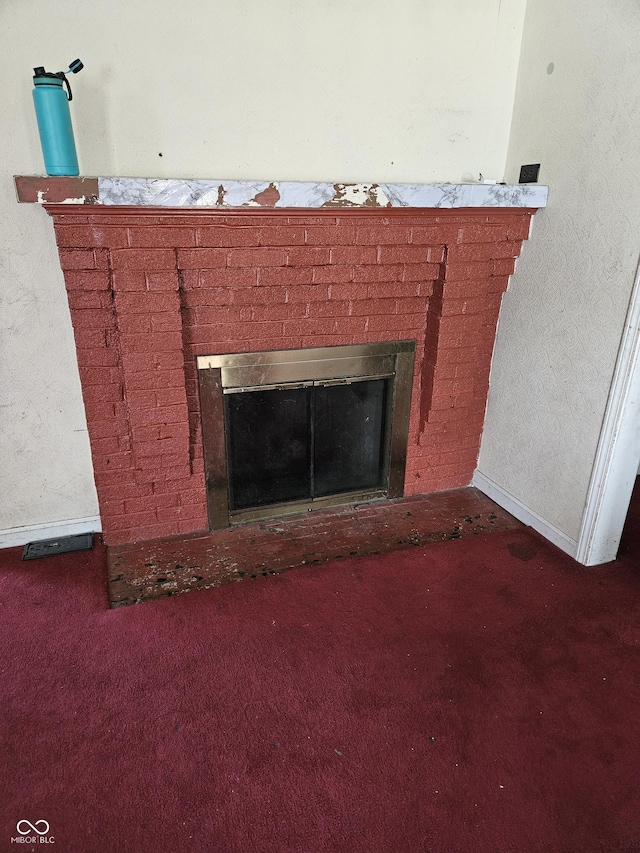 interior details with a brick fireplace and carpet