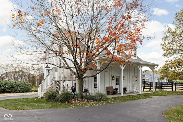 8552 E 550 S, Zionsville, IN 46077 - view of front of house with board and batten siding, a porch, and stairway