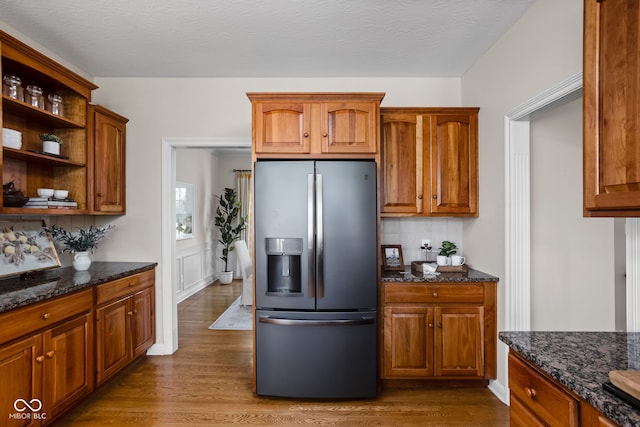 8552 E 550 S, Zionsville, IN 46077 - kitchen featuring stainless steel refrigerator with ice dispenser, dark wood-type flooring, decorative backsplash, open shelves, and dark stone countertops