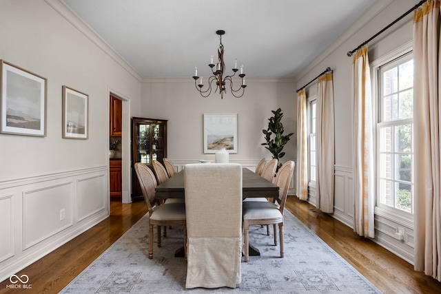 8552 E 550 S, Zionsville, IN 46077 - dining area featuring healthy amount of natural light, a chandelier, crown molding, wood finished floors, and wainscoting