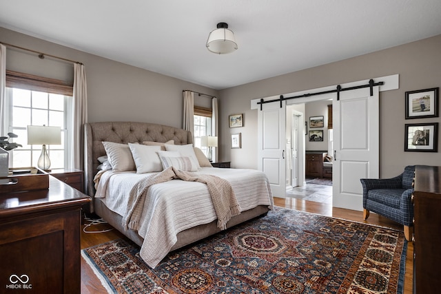 8552 E 550 S, Zionsville, IN 46077 - bedroom with a barn door and wood finished floors