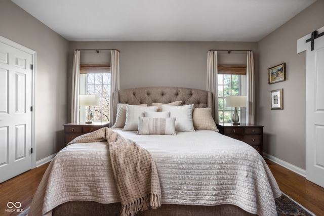 8552 E 550 S, Zionsville, IN 46077 - bedroom featuring a barn door and wood finished floors