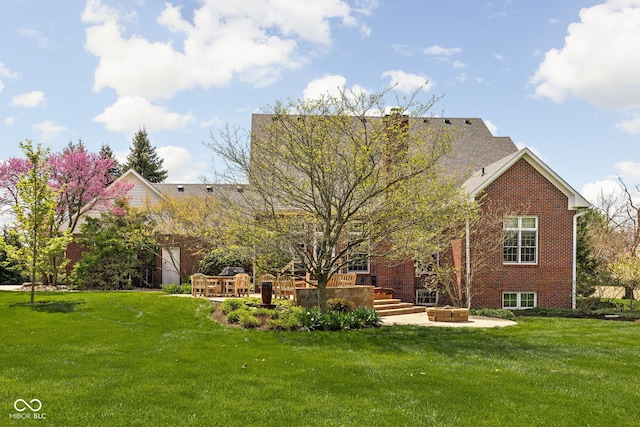 8552 E 550 S, Zionsville, IN 46077 - back of house with brick siding, a lawn, and a patio area