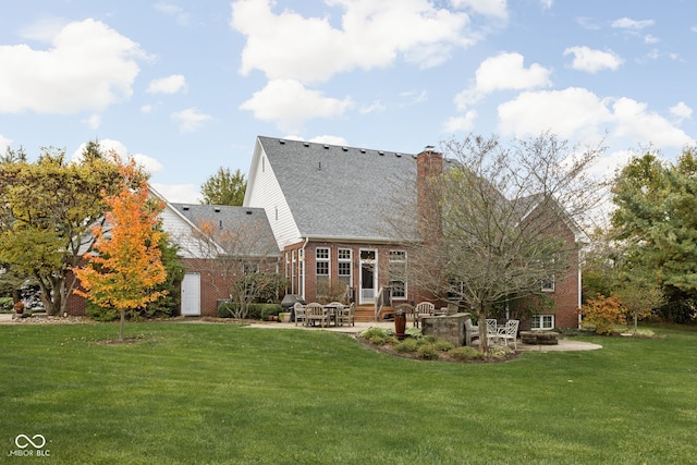 8552 E 550 S, Zionsville, IN 46077 - rear view of house featuring a patio area, a yard, entry steps, a chimney, and brick siding