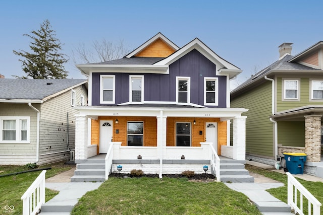 view of front of home with a front yard and covered porch