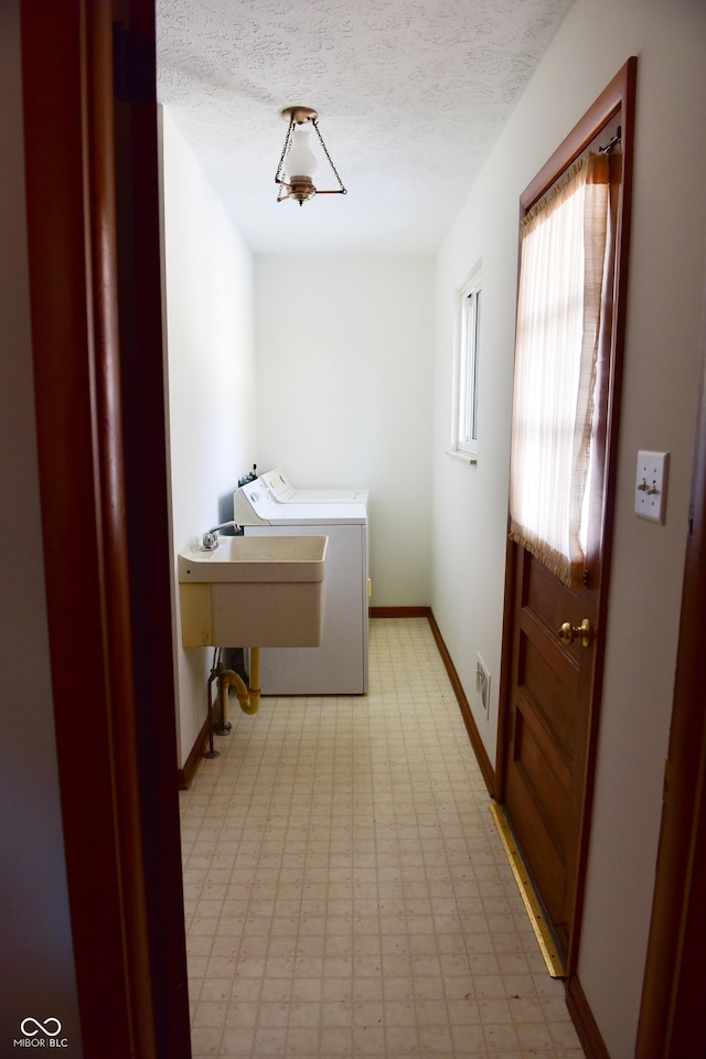 laundry area featuring a textured ceiling